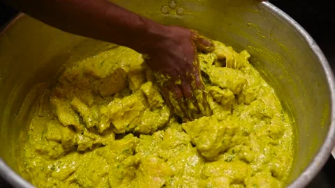 The mutton pieces are being marinated with various Indian spices Stock Footage 151763980