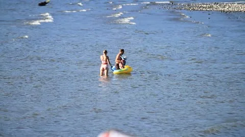 MVI 9724-couple playing with small child in River Stock Footage 8957027