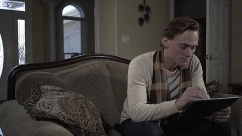 MWS Man Working on a Tablet Sitting on a Couch 動画素材 85365642