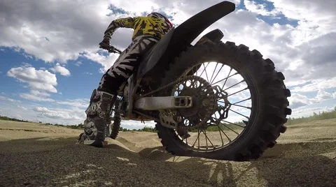 Mx spin tire in sand on camera slo mo Stock Footage 52436488