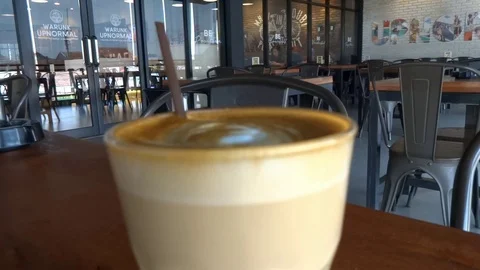 My coffee drink while im at upnormal cafe in bogor city, west java, Stock Footage 117024322