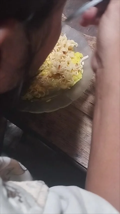 My husband eats yellow rice with noodle soup Stock Footage 294876033