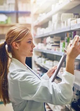 My job is to prevent medication errors. a pharmacist looking at medication on a Stock Photos