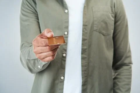 This is my method of payment. an unrecognizable man holding out his credit card Stock Photos