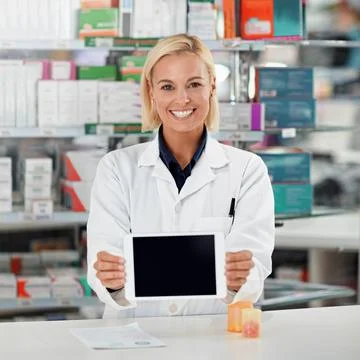 This is my secret weapon when it comes to knowledge. a pharmacist holding up a Stock Photos