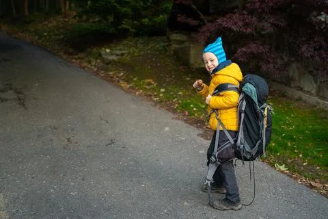 My son is facing a large backpack from his dad Stock Photos