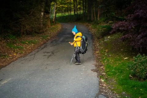 My son is facing a large backpack from his dad Stock Photos