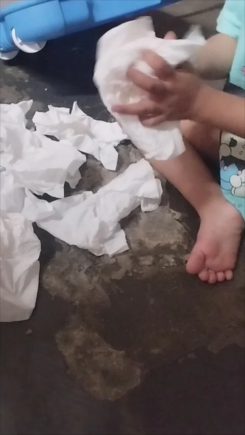 My son plays with tissue, crumples tissue Stock Footage 295328366