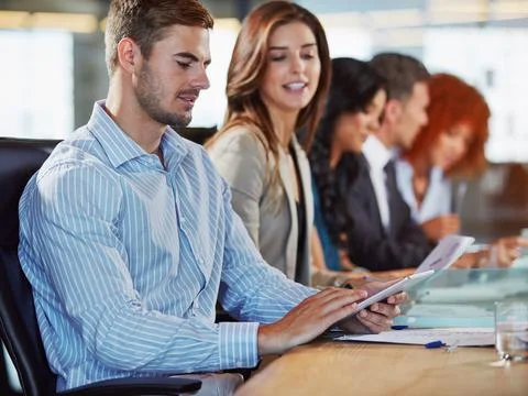 My tablet does all the note taking for me. businesspeople in the boardroom. Stock Photos