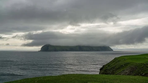 Mykines island under the clouds view from Bour 4k timelapse video, Faroe Islands Stock Footage 124005292