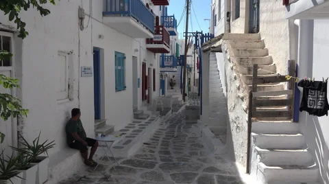 Mykonos Greece Man between white buildings 4K 133 Stock Footage 44908344