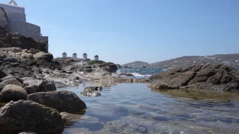 Mykonos Greece Pool of Water on Rocks with Famous Windmills in the Distance.. Stock Footage 336512963