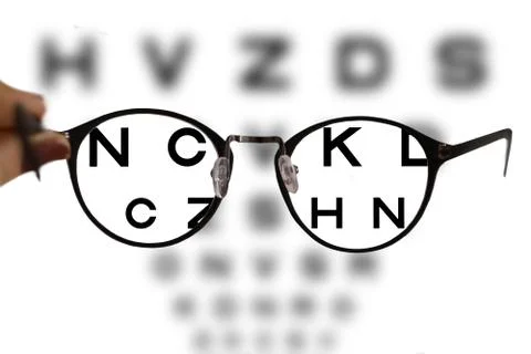 Myopia correction glasses on the eye chart letters Foto stock