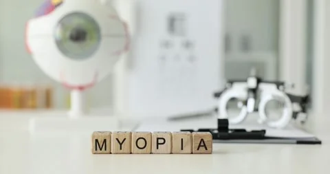 Myopia is written on wooden cubes on table in the clinic Video stock 243921294