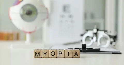 Myopia is written on wooden cubes on table in the clinic Stock Footage 258907216