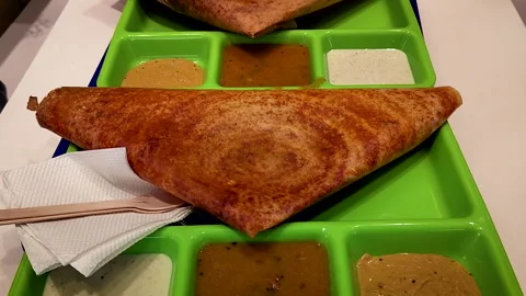 Mysore dosa served with sambar and chutneys in India Видео 332793980
