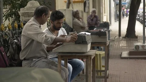 MYSORE, India - man with old typewriter on pavement sits and types Video stock 84173667