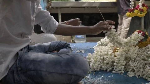 MYSORE, India - young man prepares flower garlands in the Devaraja Market Video stock 84177639