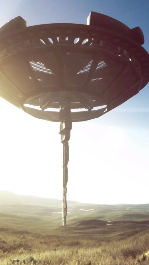 Mysterious alien ship hovers above a vast green landscape in daylight Stock Footage 329136222