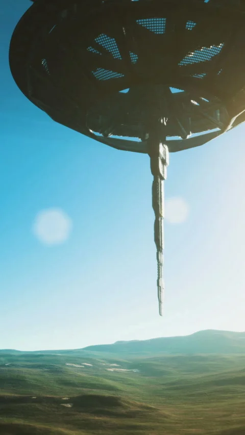 Mysterious alien ship hovers over vibrant landscape under clear blue sky Stock Footage 329174890