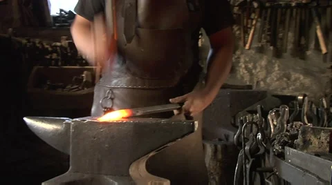 Mysterious blacksmith forges a handle for the torch. Stock Footage 49393182