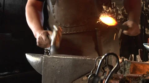 Mysterious blacksmith forges a handle for the torch. Stock Footage 49398950