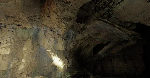 Mysterious cave interior showcasing natural rock formations and shadows Stock Illustration