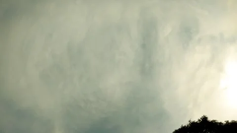 Mysterious Cloudscape: Aerial View of Sun Peeking Through Stormy Clouds Stock Footage 259883346