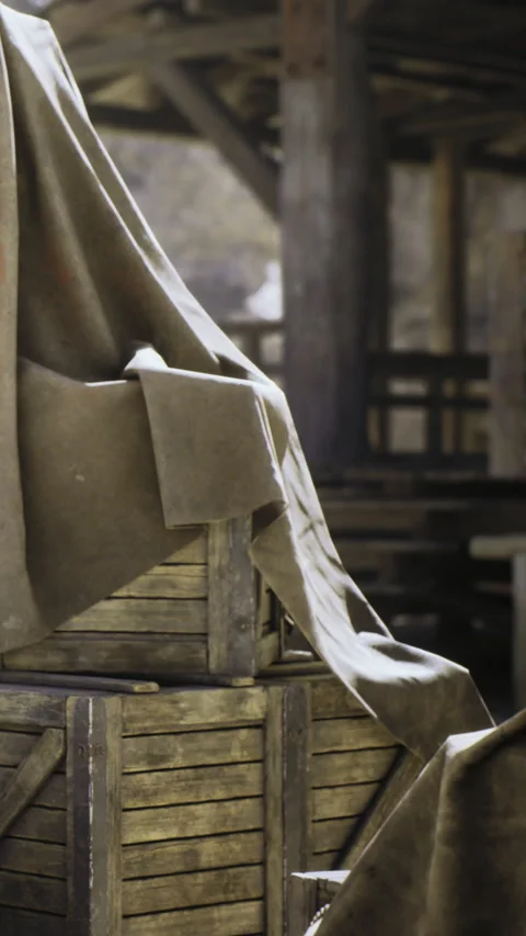 Mysterious covered crates hidden under cloth in an old rustic barn Stock Footage 331839229