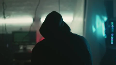 Mysterious cyber security hacker in hoodie in headquarter with computer screens Stock Footage 245484535