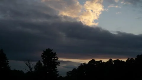 Mysterious Dawn Sky and Cloud Formations Over Tree Silhouettes Stock Footage 340659900