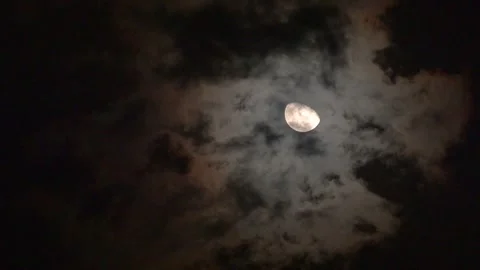 Mysterious Full Moon Partially Hidden Behind Dark Dramatic Storm Clouds at .. Stock Footage 341408805