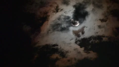 Mysterious Full Moon Partially Hidden Behind Dark Dramatic Storm Clouds at .. Stock Footage 341408812