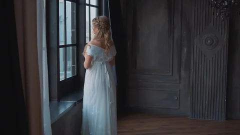 Mysterious ghost in old dark castle, girl with blond hair and white long dress Stock Footage 104015660