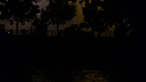 Mysterious glowing light emerging from dark river waters Stock Footage 332801731