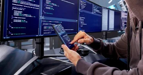 The Mysterious Hacker In Balaclava Steals Data From Stolen Phone. Stock Photos