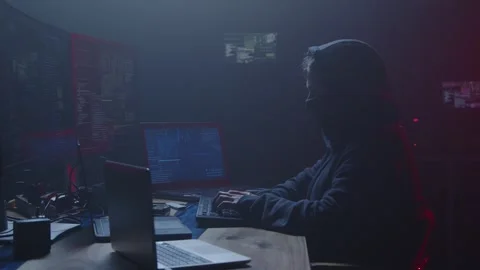 A mysterious hacker is diligently working late at night in a dark room Stock Footage 281759476