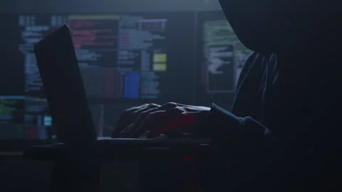 A Mysterious Hacker Engaged in Work Late at Night in the Shadows Stock Footage 281759641