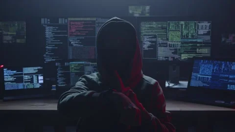 A Mysterious Hacker Is Found in a Dark Room Surrounded by Numerous Monitors Stock Footage 281759377