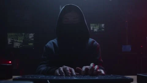 A mysterious hacker is present in a dark and shadowy environment Stock Footage 281759788