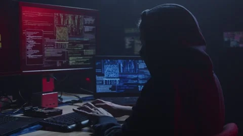 A Mysterious Hacker is Present in a Dark Room Surrounded by Multiple Screens Stock Footage 281759525