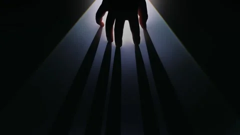 Mysterious Hand Casting Long Shadows in Dark Light Stock Footage 311933685