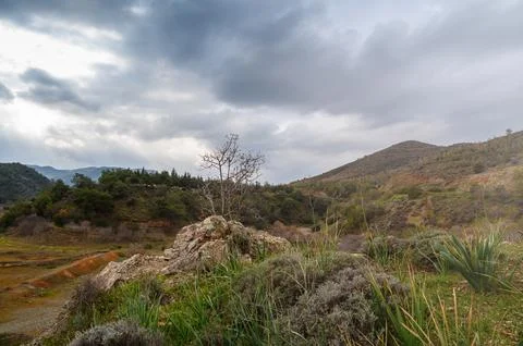 Mysterious landscape under dramatic clouds in a serene mountain valley Foto stock