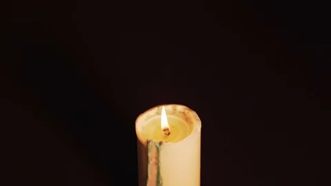 Mysterious magic close-up - women's hands conjure over a burning candle in Stock Footage 124860461