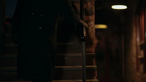 Mysterious man walks down staircase Stock Footage 42891845