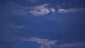 Mysterious moon hiding behind clouds, shining brightly in dark night sky, dreams 4k or 4k+ Resolution