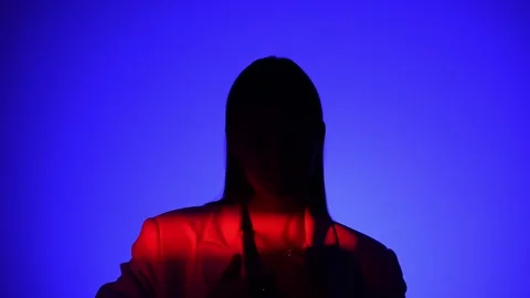 Mysterious Person in Dramatic Blue and Red Lighting Effect Stock Footage 310497973