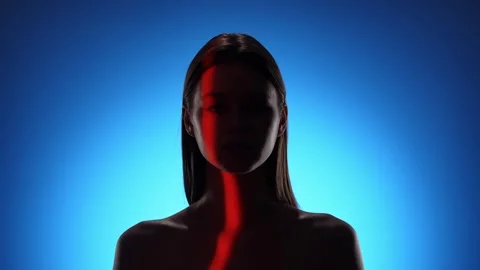 Mysterious Person in Dramatic Blue and Red Lighting Effect 스톡 동영상 310498160