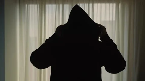 Mysterious person's silhouette against apartment window wearing his hoodie Stock Footage 340193353