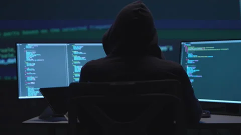 Mysterious Programmer Working on Multiple Computer Screens in a Low-Light E.. Stock Footage 336679269